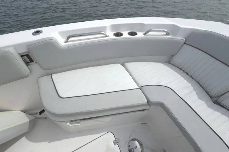 Slide: The Image of 2022 Sea Fox 248 Commander boat interior with cushioned seating and cup holders. - 33