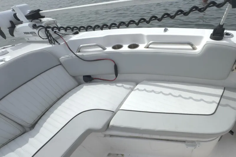 Slide: The Image of 2022 Sea Fox 248 Commander boat interior with white cushioned seating and cup holders. - 36