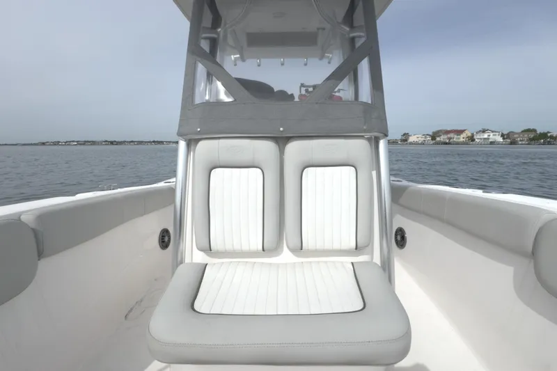 Slide: The Image of 2022 Sea Fox 248 Commander boat interior with cushioned seating on calm water. - 39