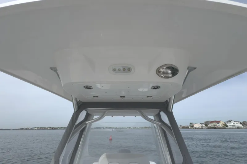 Slide: The Image of 2022 Sea Fox 248 Commander boat's T-top view with ocean backdrop. - 40