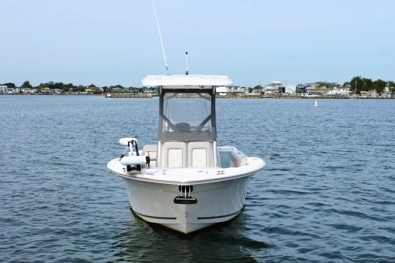 Slide: The Image of 2022 Sea Fox 248 Commander boat on calm water, coastal background. - 6