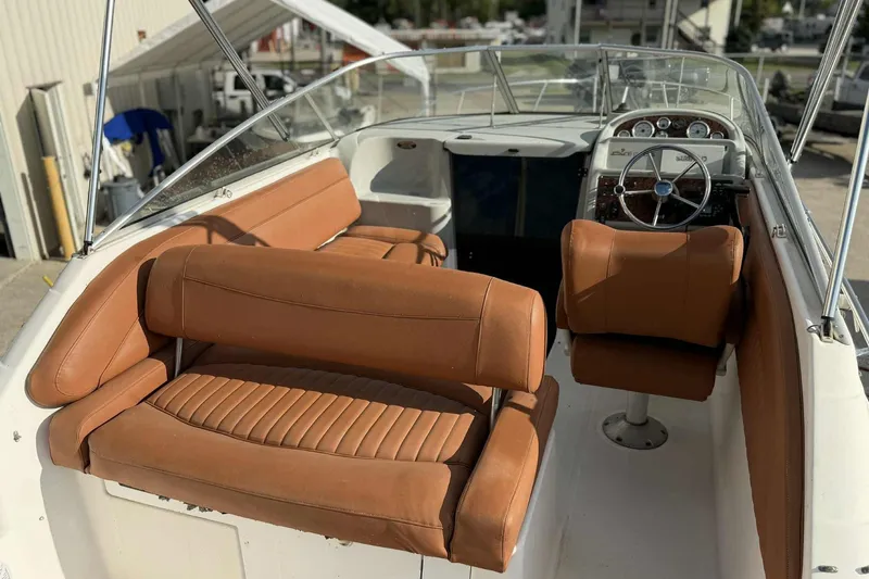 Slide: The Image of 1999 Bayliner 2655 Ciera boat interior with tan leather seating and steering wheel. - 11