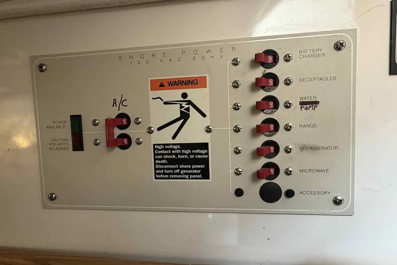 Slide: The Image of Electrical control panel on a 1999 Bayliner 2655 Ciera boat with warning label. - 12