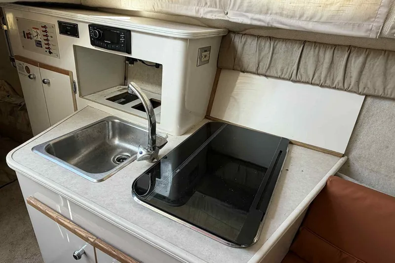 Slide: The Image of 1999 Bayliner 2655 Ciera boat kitchenette with sink and stove. - 13