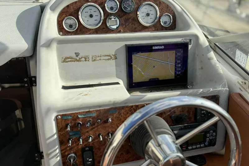 Slide: The Image of 1999 Bayliner 2655 Ciera dashboard with navigation system and steering wheel. - 2