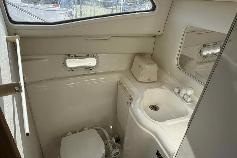 Slide: The Image of 1999 Bayliner 2655 Ciera boat bathroom with sink, toilet, and window. - 7