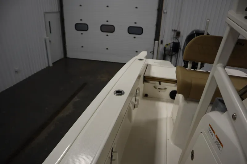 Slide: The Image of 2024 Bayliner Trophy T22CC boat interior in a garage setting. - 20