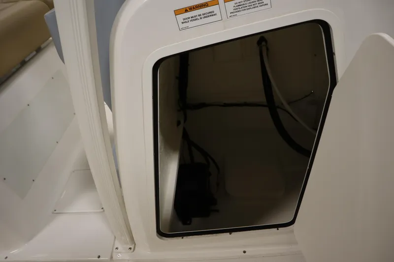 Slide: The Image of 2024 Bayliner Trophy T22CC storage compartment with open hatch, showcasing interior space. - 22