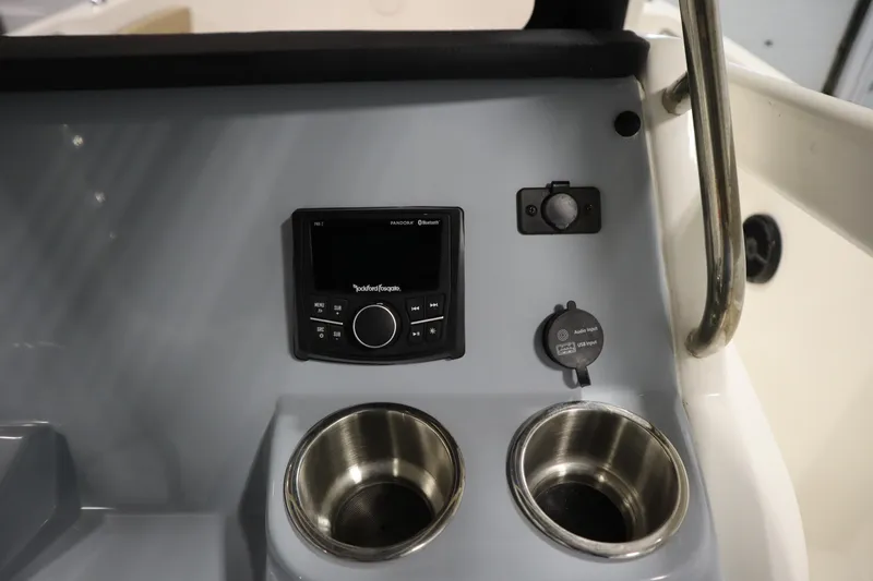 Slide: The Image of 2024 Bayliner Trophy T22CC dashboard with audio system and cup holders. - 27