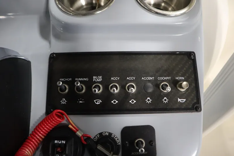 Slide: The Image of Control panel of 2024 Bayliner Trophy T22CC boat with switches and cup holders. - 28