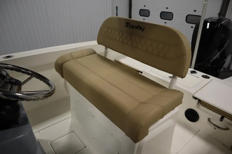 Slide: The Image of 2024 Bayliner Trophy T22CC boat interior with tan seating and steering wheel. - 29