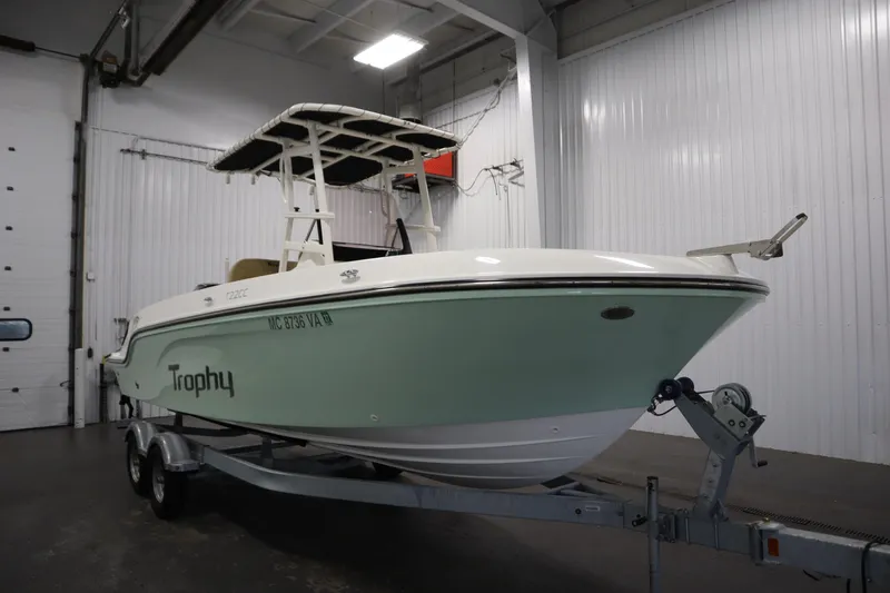 Slide: The Image of 2024 Bayliner Trophy T22CC boat on trailer in indoor storage facility. - 3