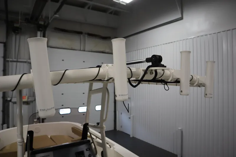 Slide: The Image of 2024 Bayliner Trophy T22CC boat rod holders in a garage setting. - 31