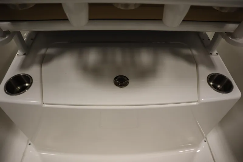Slide: The Image of 2024 Bayliner Trophy T22CC boat interior with cup holders and storage compartment. - 32