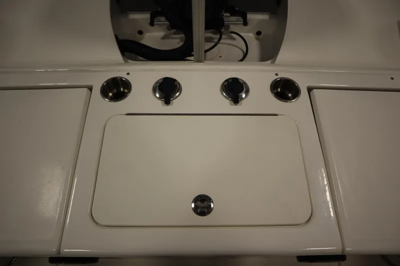 Slide: The Image of 2024 Bayliner Trophy T22CC boat console with cup holders and storage compartments. - 36