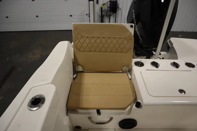Slide: The Image of 2024 Bayliner Trophy T22CC boat seat with tan upholstery and cup holders. - 39
