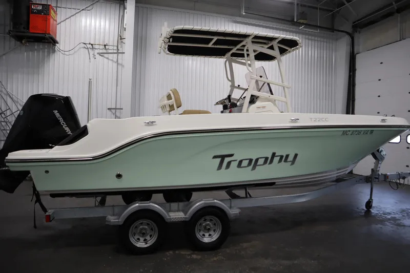 Slide: The Image of 2024 Bayliner Trophy T22CC boat on trailer in indoor storage. - 4
