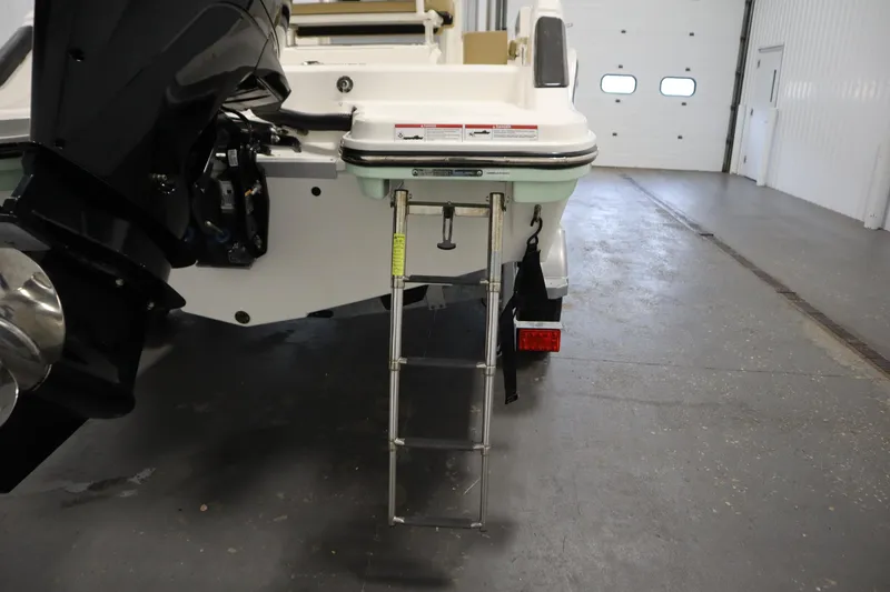 Slide: The Image of 2024 Bayliner Trophy T22CC boat with ladder and motor in a garage. - 41