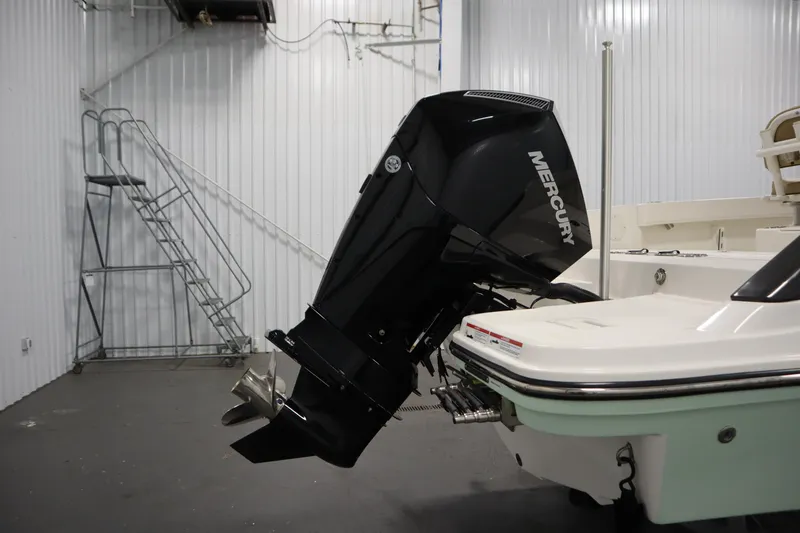 Slide: The Image of 2024 Bayliner Trophy T22CC with Mercury outboard motor in a storage facility. - 43