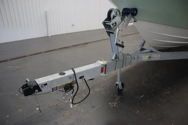 Slide: The Image of 2024 Bayliner Trophy T22CC boat trailer hitch in a garage setting. - 45