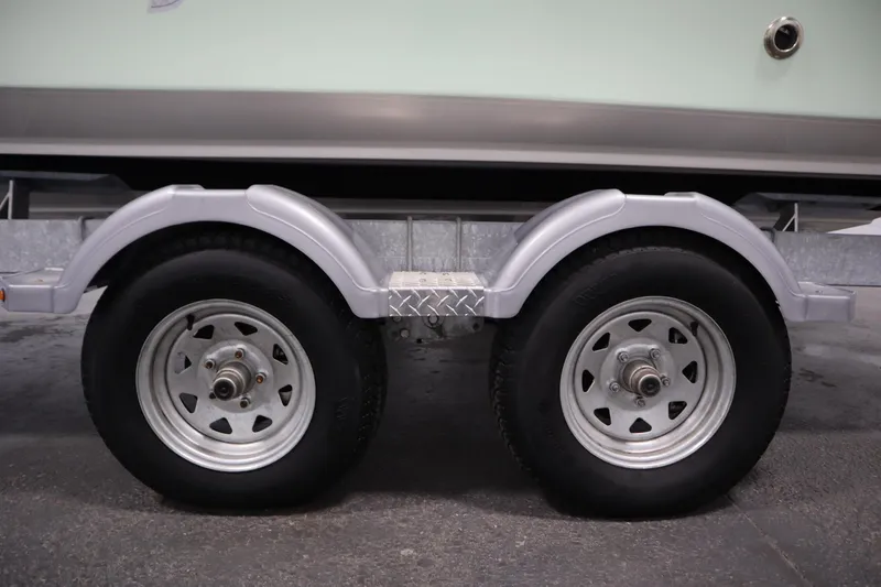 Slide: The Image of Trailer wheels of 2024 Bayliner Trophy T22CC boat, showcasing dual axle design. - 47