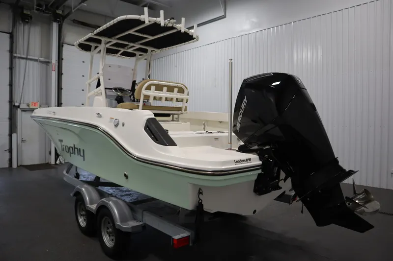 Slide: The Image of 2024 Bayliner Trophy T22CC boat with Mercury engine on trailer in indoor storage. - 7