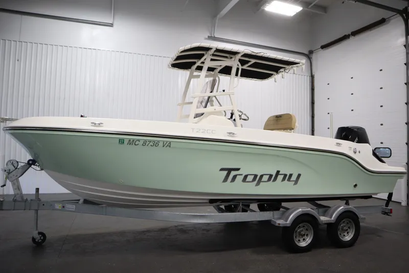 Slide: The Image of 2024 Bayliner Trophy T22CC boat on trailer in indoor showroom. - 8
