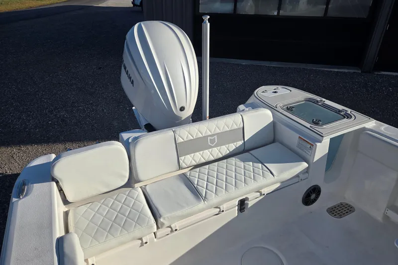 Slide: The Image of 2026 Sea Fox 248 Commander boat interior with cushioned seating and Yamaha outboard motor. - 10