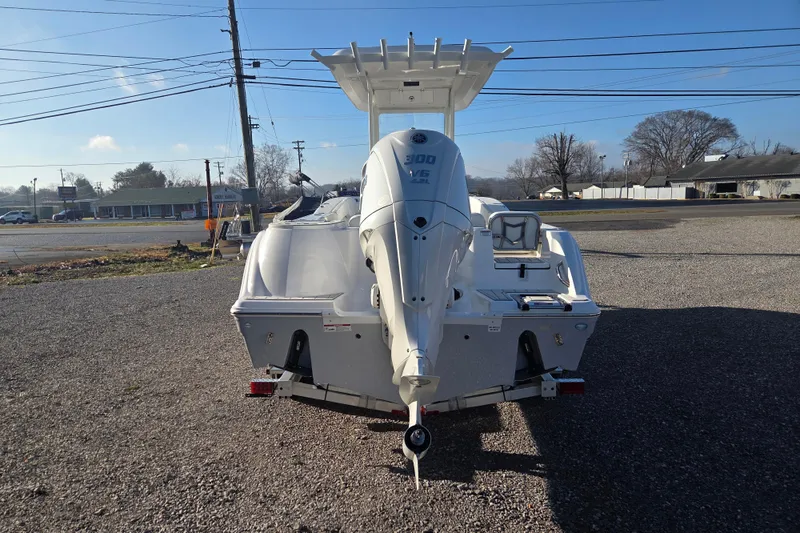 Slide: The Image of 2026 Sea Fox 248 Commander boat with powerful outboard motor, parked on gravel lot. - 3