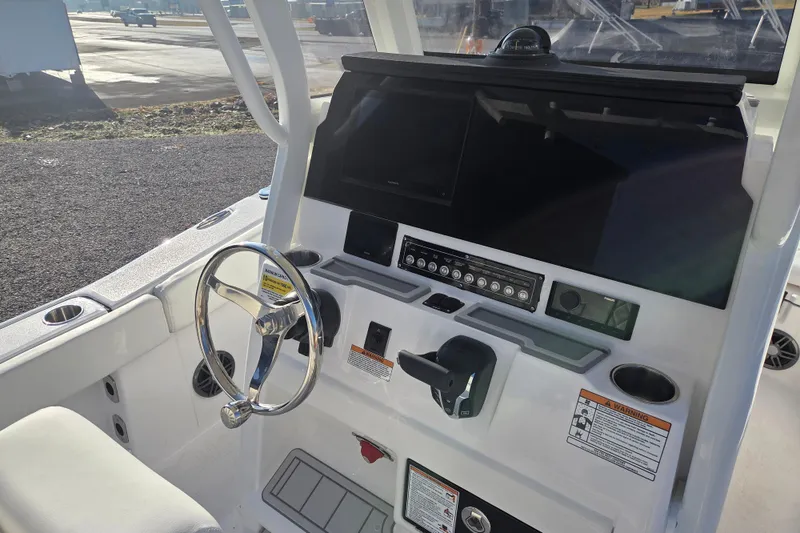Slide: The Image of 2026 Sea Fox 248 Commander boat dashboard with steering wheel and control panel. - 7