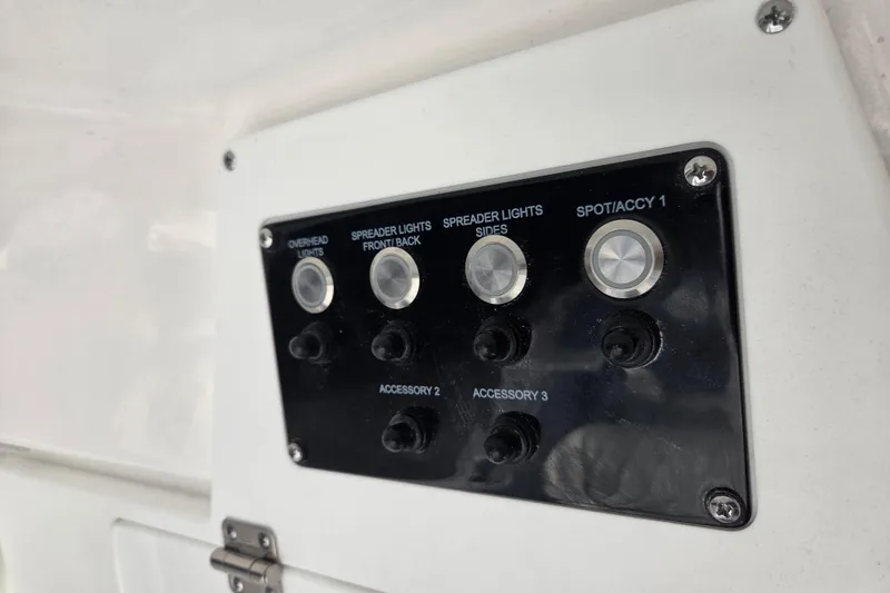 Slide: The Image of Control panel on 2026 Sea Fox 248 Commander boat with various light switches. - 9