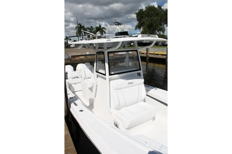 Slide: The Image of 2026 Limitless 270 boat with sleek white design docked by the water. - 14