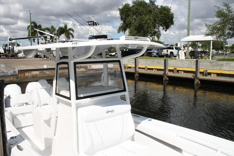 Slide: The Image of White Limitless 270 boat docked by the water, showcasing sleek design and modern features. - 15