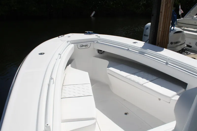 Slide: The Image of Front seating area of a 2026 Limitless 270 boat, docked with Yamaha engine visible. - 16