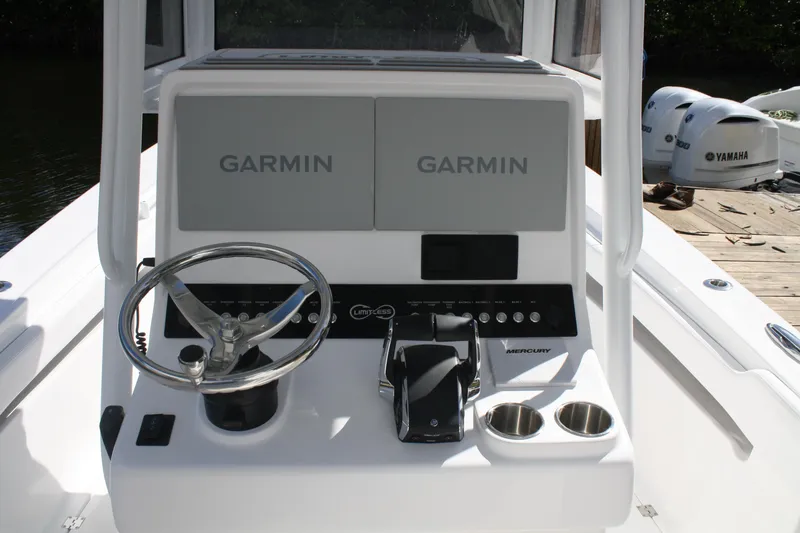 Slide: The Image of Steering console of Limitless 270 boat, featuring Garmin displays and Mercury controls, 2026 model. - 21