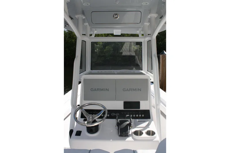 Slide: The Image of Limitless 270 boat console with Garmin displays, steering wheel, and controls, 2026 model. - 22