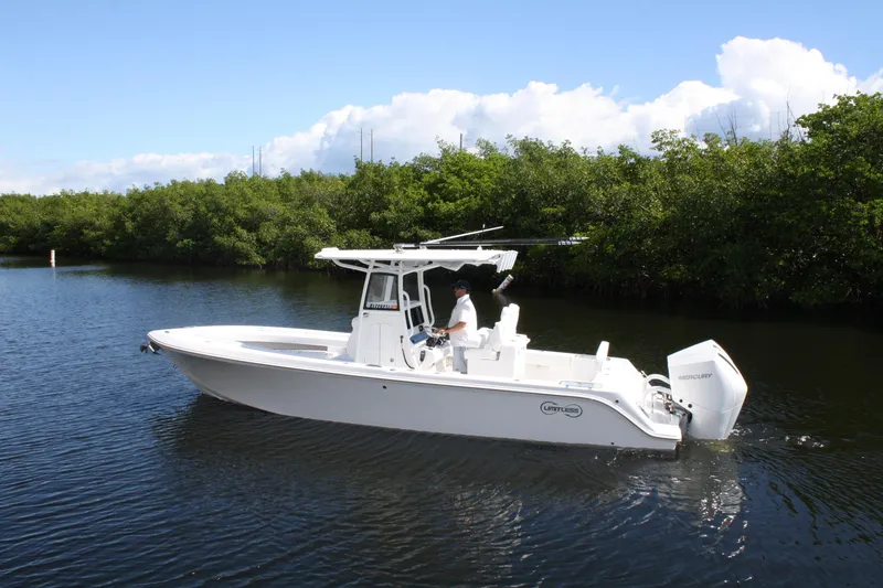 Slide: The Image of 2026 Limitless 270 boat cruising on a calm river with lush greenery. - 28