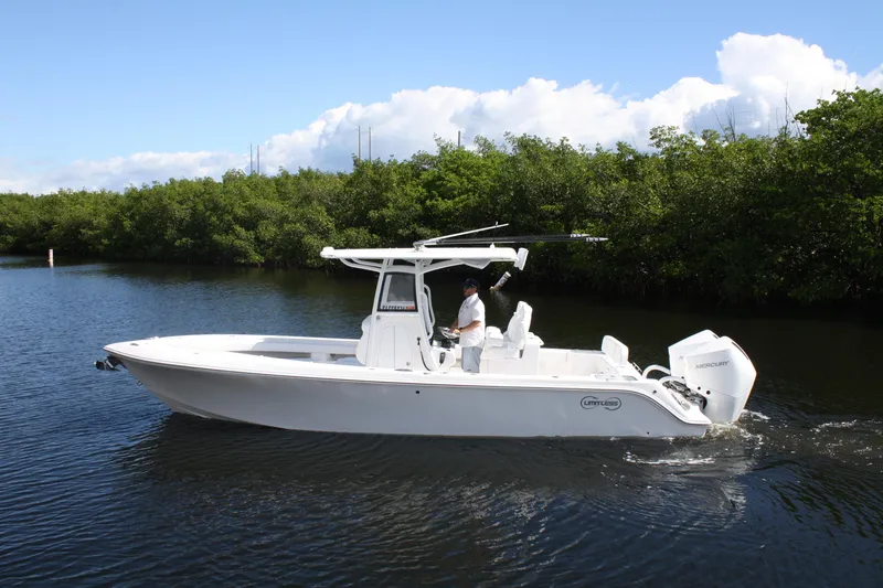 Slide: The Image of 2026 Limitless 270 boat cruising on a calm river with lush greenery. - 29