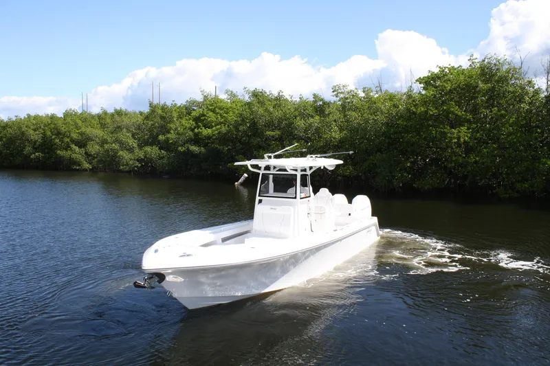 Slide: The Image of A 2026 Limitless 270 boat cruising on a calm river with lush greenery. - 30