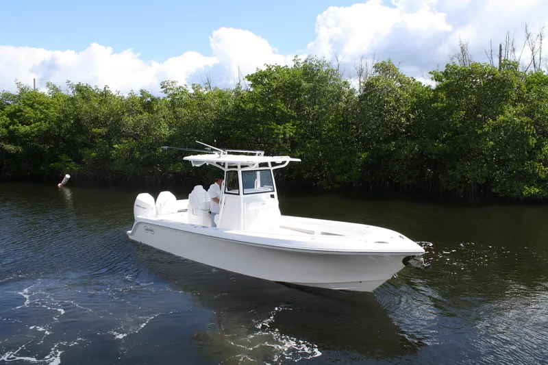 Slide: The Image of White Limitless 270 boat cruising on a calm river, surrounded by lush greenery, 2026 model. - 34