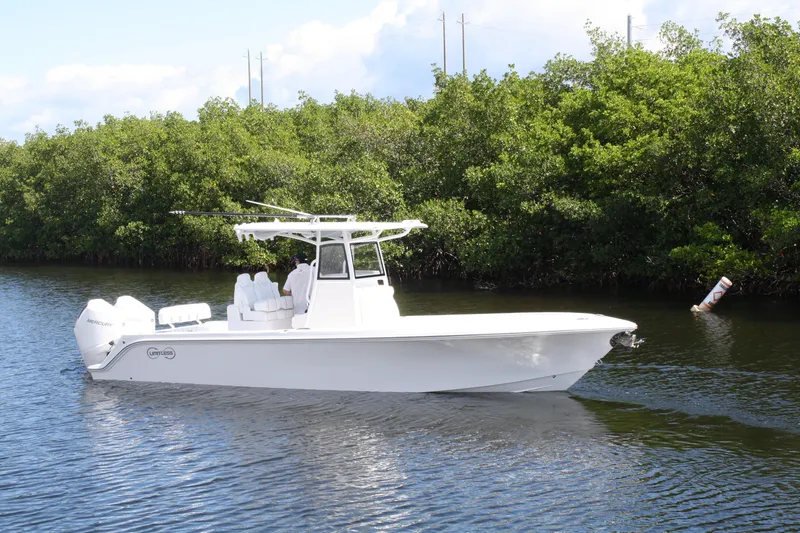 Slide: The Image of A sleek 2026 Limitless 270 boat cruising on a calm river near lush greenery. - 35