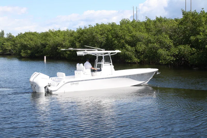 Slide: The Image of 2026 Limitless 270 boat cruising on a calm river with lush greenery. - 37