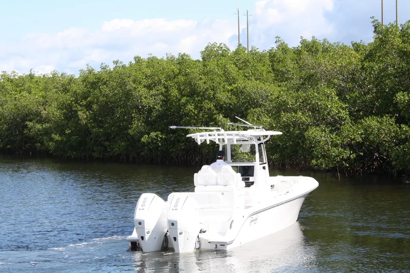 Slide: The Image of White Limitless 270 boat cruising through lush mangrove-lined waterway, 2026 model. - 39