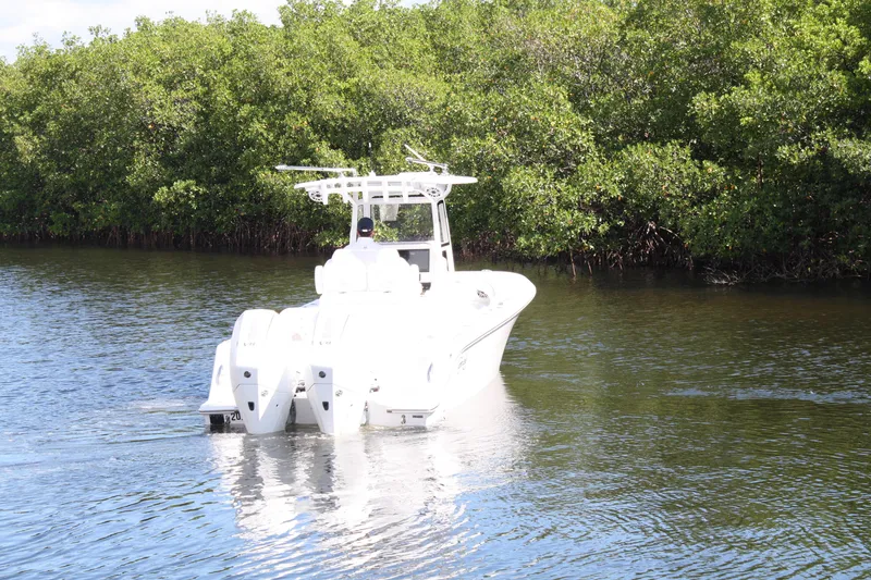 Slide: The Image of A 2026 Limitless 270 boat navigating a serene waterway surrounded by lush greenery. - 40