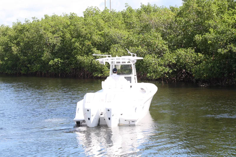 Slide: The Image of A 2026 Limitless 270 boat navigating a calm waterway surrounded by lush greenery. - 41