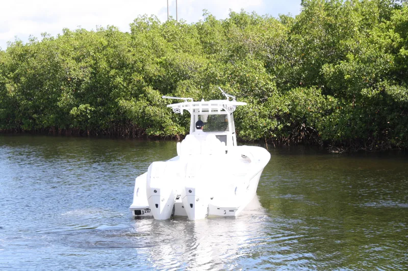 Slide: The Image of Limitless 270 boat cruising on a calm river, surrounded by lush greenery, 2026 model. - 42