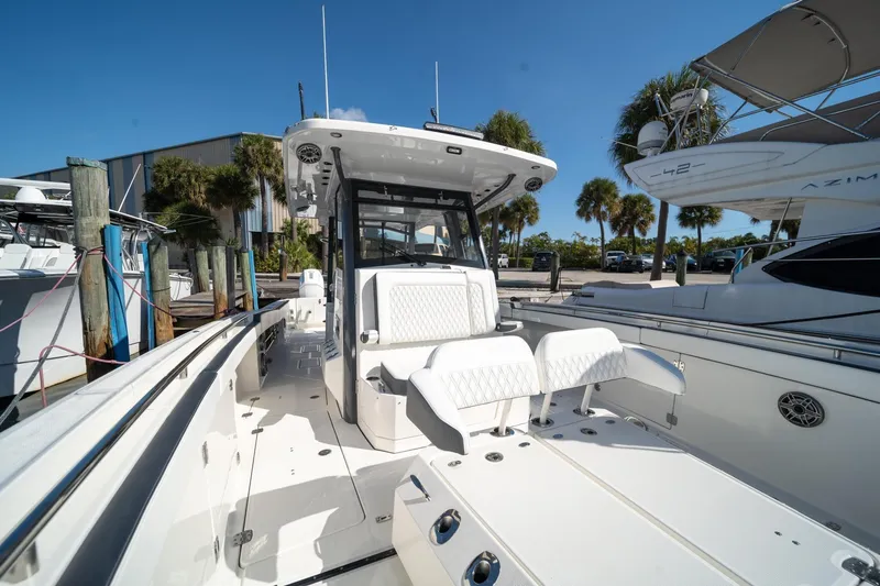 Slide: The Image of 2022 World Cat 400 CC-X boat with sleek design, docked under clear blue sky. - 12