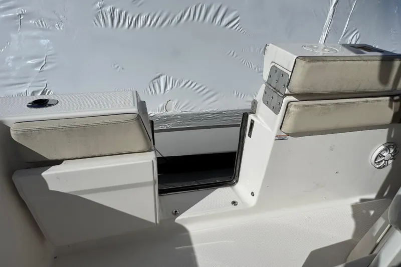 Slide: The Image of 2019 Robalo R272 Center Console boat interior with cushioned seating and storage. - 10