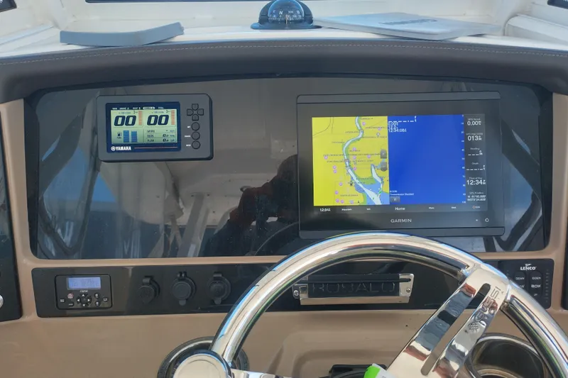 Slide: The Image of 2019 Robalo R272 Center Console dashboard with Garmin navigation and Yamaha display. - 11