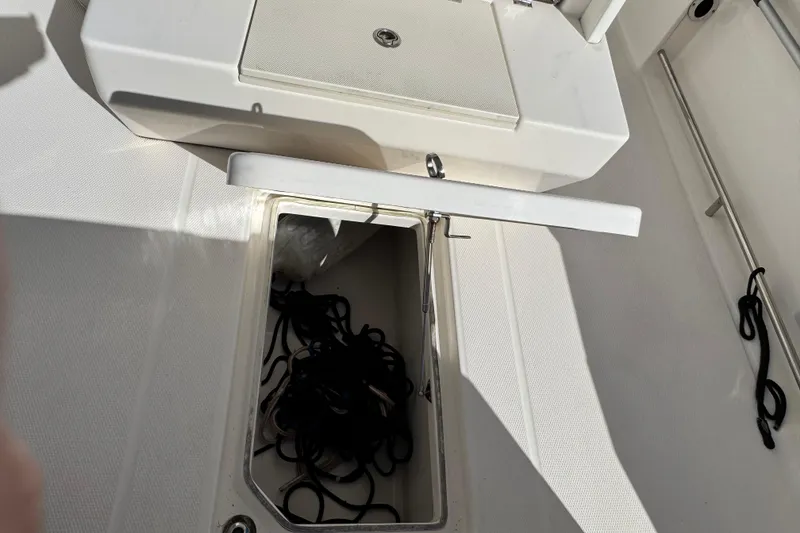 Slide: The Image of 2019 Robalo R272 Center Console boat storage compartment with ropes inside. - 13